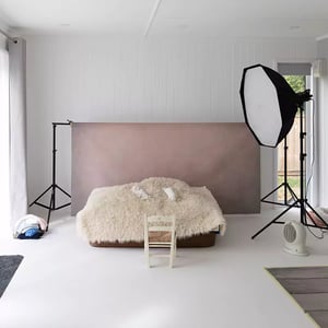 Large photography studio in garden with props and lighting setup inside