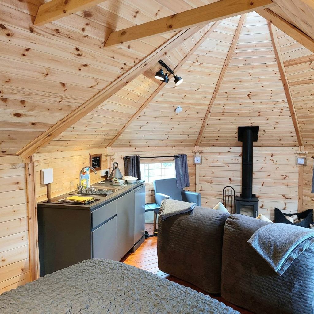 Interior of a rustic timber glamping cabin by Cabin Master