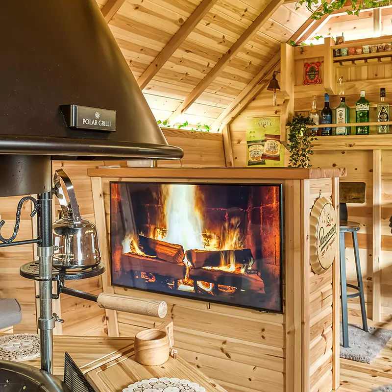 Inside a fantastic timber garden bar hut with bbq unit