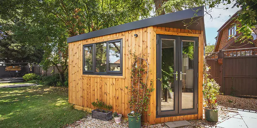 Small insulated garden corner room in redwood 