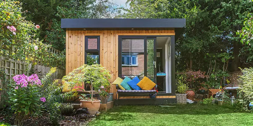 Small compact garden room in nice neat garden 