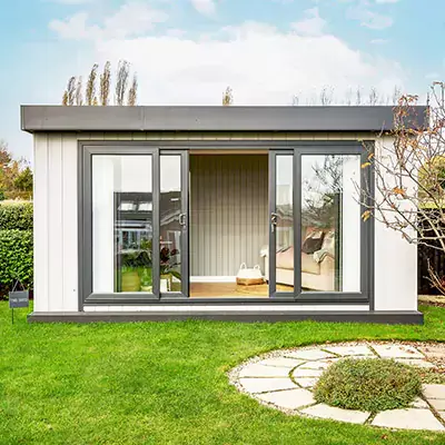 Looking into a bespoke garden office, desk and laptop can be seen