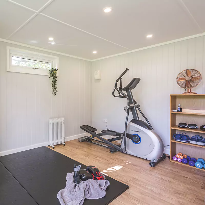 Interior of a garden gym with bench & weights