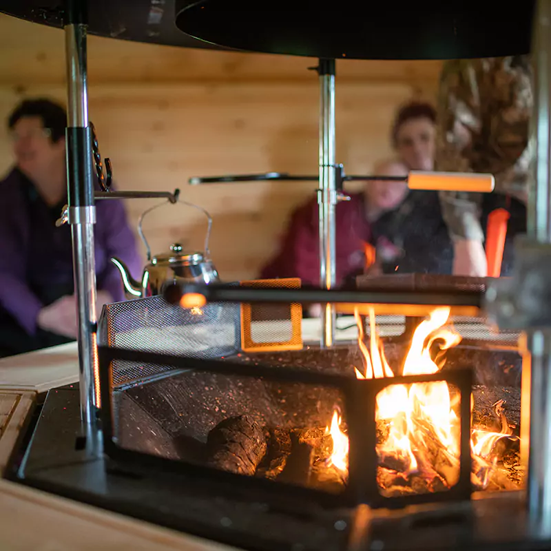 forest school cabin with fire lit inside