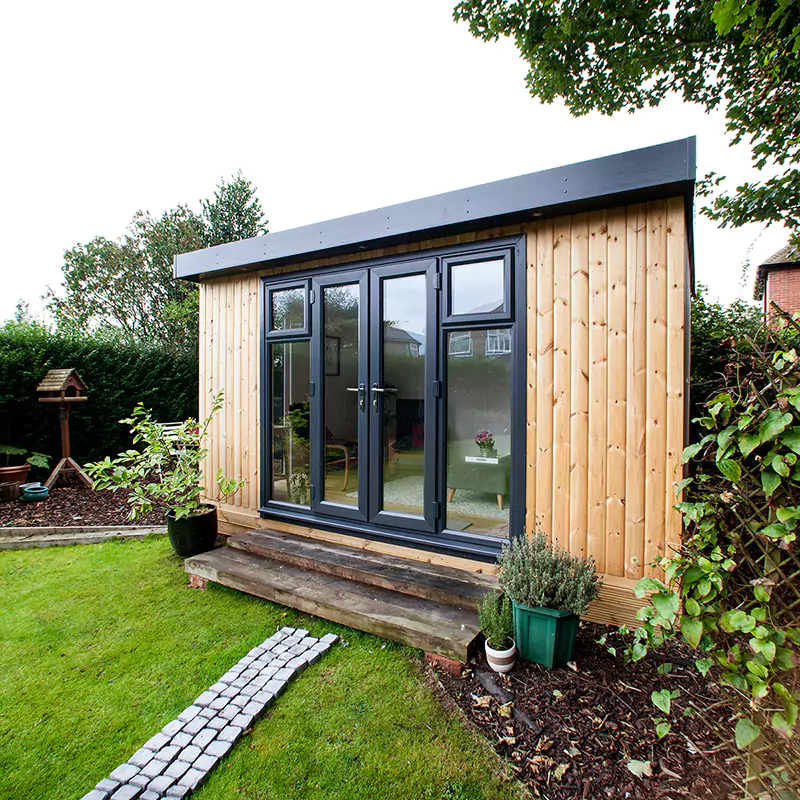 small garden pod redwood office with patio walkway and lawn area and timber steps