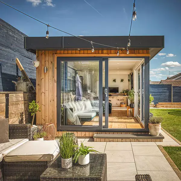 Small garden summerhouse with open french doors