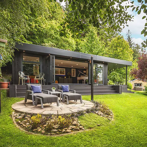 Small garden summerhouse with bistro table outside