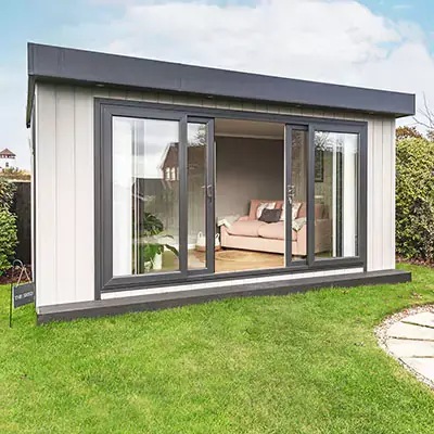 Zero maintenance garden office with bi-fold doors in neat garden with pond and pumpZero maintenance garden office with bi-fold doors in neat garden with pond and pump