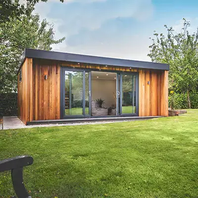 Cedar garden room gym clad in cedar with sliding doors