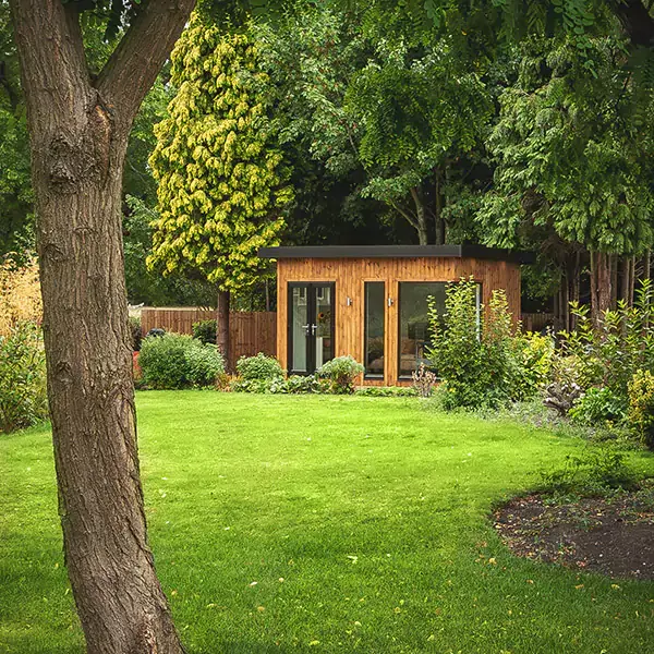 redwood garden room hobby and craft studio with french doors and  potted plants