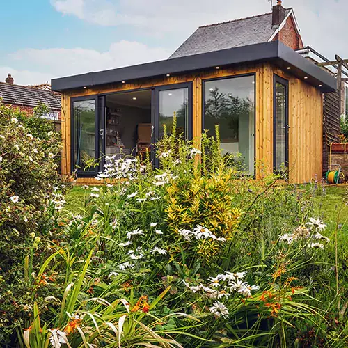 Small redwood garden room with outdoor seating & cushions