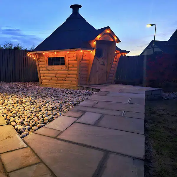 Arctic BBQ cabin lit up at night