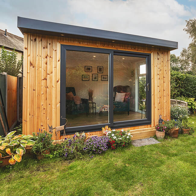 Cabin Master redwood summerhouse with large sliding doors to the front